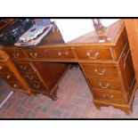 A pedestal desk with inset brown leather top