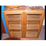 An Ercol two door display cabinet