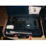 A Bosch electric hammer tool with case and instruc