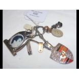 A silver Porsche keyring together with a 'photogra