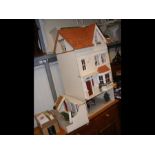 A doll's house with fitted interior and some furni