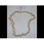 A four strand fresh water pearl necklace with yell