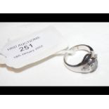 A three stone diamond designer ring in 18ct white