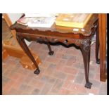An antique pie-crust occasional table on cabriole