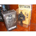 An unopened Batman figure and one other