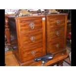 A pair of mahogany three drawer bedside cabinets