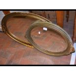 Two gilt framed oval wall mirrors