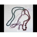 A malachite necklace together with four other neck