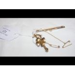 A 15ct gold flower brooch, together with one other