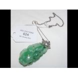 A jade and diamond pendant on chain