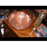 A two handled copper skillet together with coffee