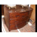 A bow front chest of three long drawers