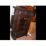 A Victorian Continental carved oak cabinet