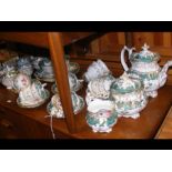 A decorative antique tea service with floral desig