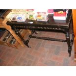 An antique ebonised fold over games table