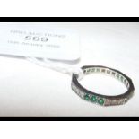 An 18ct emerald and diamond eternity ring - size M