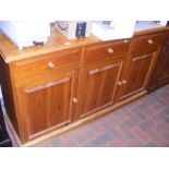 A pine sideboard with drawers and cupboards below