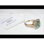 An attractive square cut emerald and diamond ring