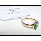 A diamond and emerald 18ct ring - size M