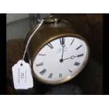A circular French bedside clock with enamel face -