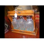 An antique three bottle tantalus