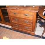 An antique satin walnut chest of drawers featuring