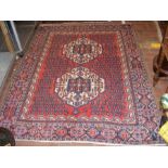 A Middle Eastern rug with geometric border and two