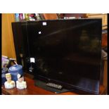 An LG flat screen TV with remote