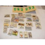 A box containing vintage cigarette cards (approx.