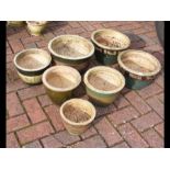 Seven garden pots of varying size