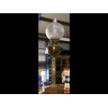 A Victorian brass oil lamp with glass shade