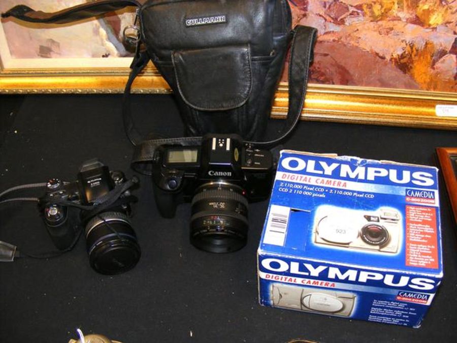 A Canon EOS 650 camera, together with two others