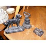 A cast iron 'dog' door stop together with other co