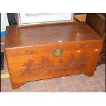 A carved oriental camphorwood blanket chest with d