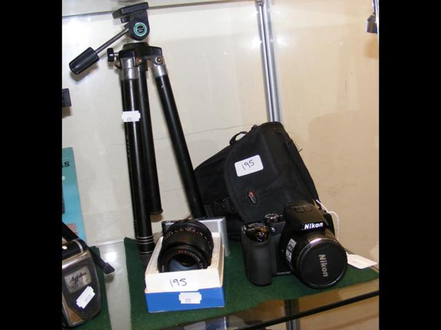 A Nikon Digital Camera with lens, tripod and carry