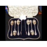 A set of six silver teaspoons with sugar tongs in