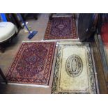 A small Middle Eastern rug together with two other