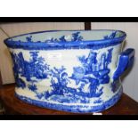 An antique blue and white foot bath with mark to b