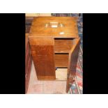 A Victorian oak two door cabinet by the Goldsmiths