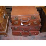 Four graduated leather vintage suitcases