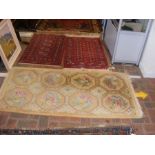 Two small Middle Eastern rugs with red ground toge