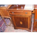 An Edwardian cupboard with single drawer to the fr
