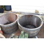 A pair of oak wine barrel planters