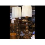 A pair of old gilt table lamps - 122cms high