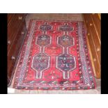 A Middle Eastern rug with central medallions and r