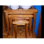 A nest of three hardwood occasional tables