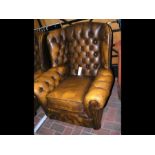 An antique style wing back armchair