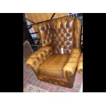 An antique style wing back armchair