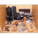 A medley of vintage cameras and smoking parapherna