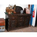A Victorian carved oak sideboard with drawers and